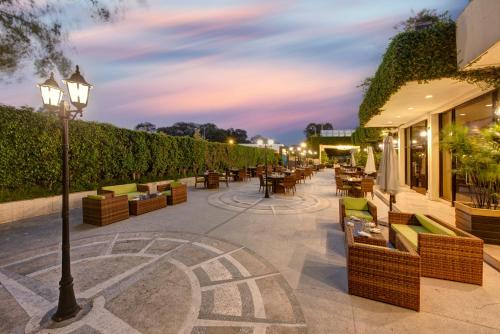a patio with tables and chairs and a street light at Pearl Continental Hotel, Rawalpindi in Rawalpindi