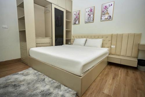 a bedroom with a large white bed and a mirror at An's House SaPa - Nguyên Căn 5 Phòng Ngủ View Núi in Sa Pa