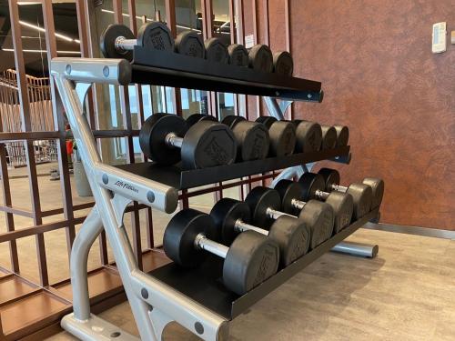 a bunch of dumbbells on a rack in a gym at Edge Central Pattaya By Su in Pattaya Central