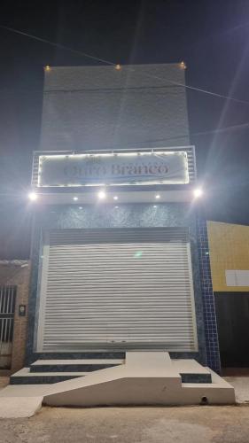 a building with a garage entrance with a skateboard in front at Pousada Ouro Branco in Macau