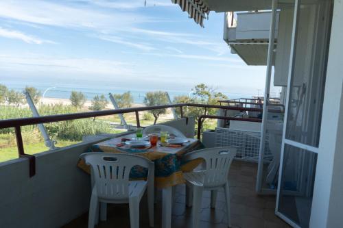 a table and chairs on a balcony with a view of the ocean at Gioiamare in Martinsicuro