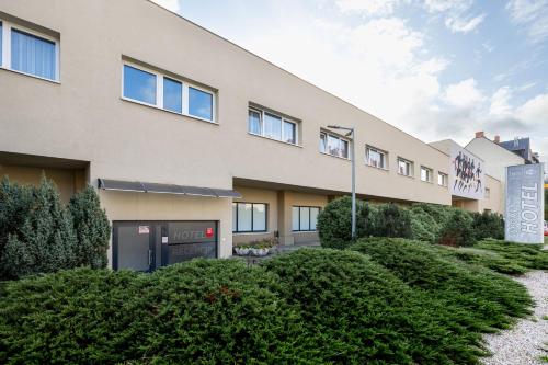 a building with bushes in front of it at Sport Hotel in Jelenia Góra