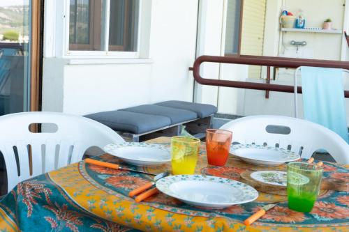 a table with two chairs with plates and drinks on it at Gioiamare in Martinsicuro
