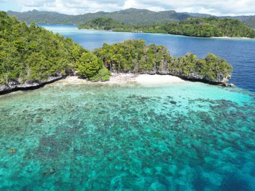 an aerial view of an island in the ocean at Friwen Mangrove Eco Lodge in Yennanas Besir