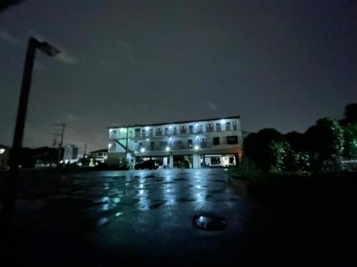a building is lit up at night at 彦根びわこホテル裏のマンション 一室貸し切り50台無料駐車場付き台所あり自転車貸出可 BbQ可 ペット同伴可 in Hikone