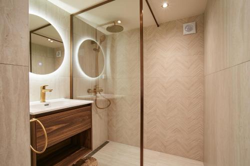 a bathroom with a shower and a sink at Seaside design apartment in Scheveningen