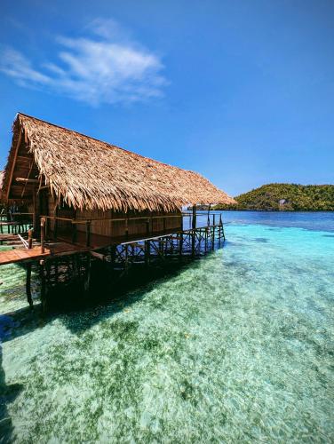 a building on the water in the ocean at Friwen Mangrove Eco Lodge in Yennanas Besir