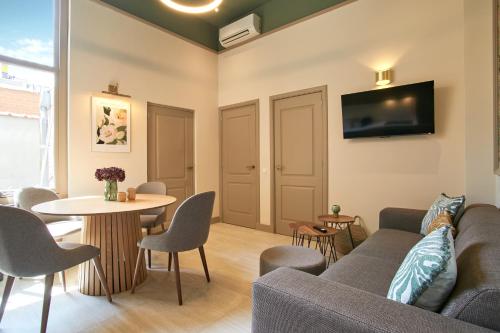 a living room with a couch and a table at Seaside design apartment in Scheveningen