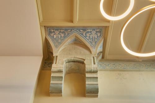 a staircase in a building with a painting on the ceiling at Seaside design apartment in Scheveningen