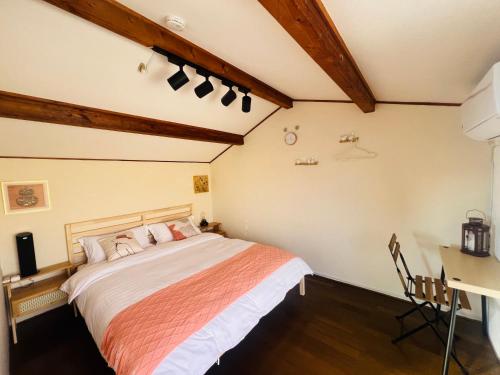 a bedroom with a bed and a desk at 旭house in Osaka