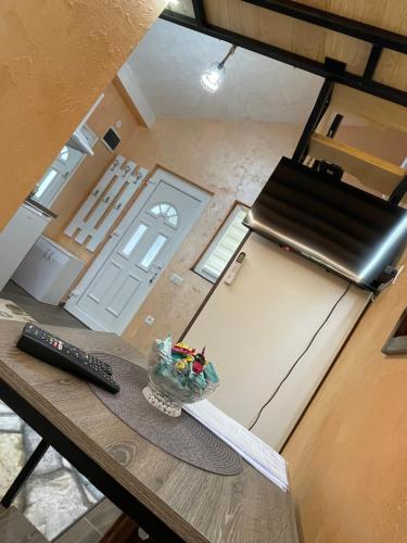 an overhead view of a kitchen with a table with a remote control at APARTMAN OAZA 24 in Surčin