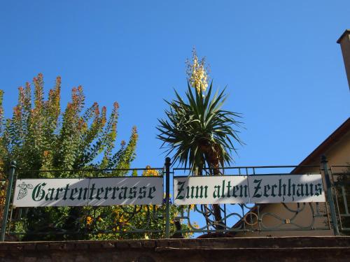 a sign on a gate in front of some trees at Boutique Hotel Ur-Wachau in Weissenkirchen in der Wachau