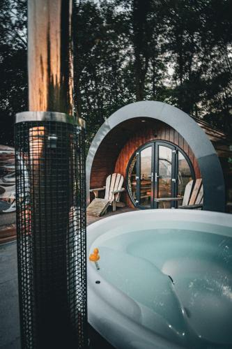a bath tub in front of a building with a fire place at Catgill Farm in Bolton Abbey