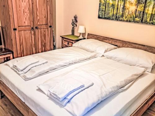 two beds with white sheets and towels on them at Apartment Schönblick Mountain Resort & Spa-1 by Interhome in Rauris