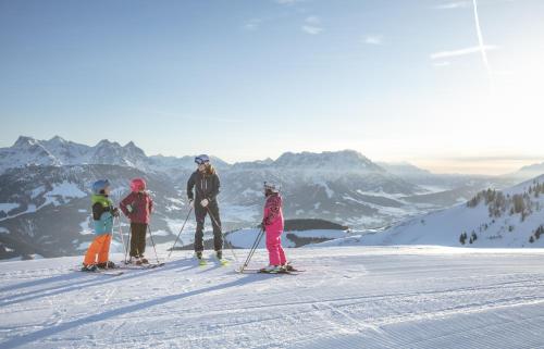 a group of people on skis on a mountain at Kitzbühel Suites by ALPS RESORTS in Oberndorf in Tirol