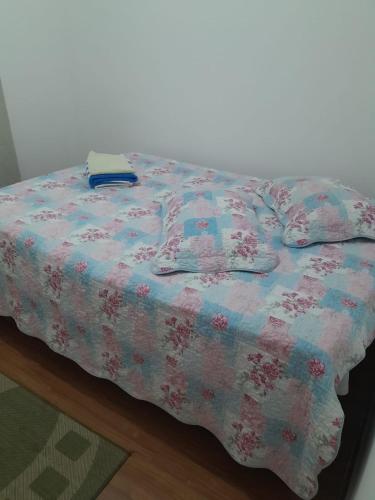 - un lit avec une couverture dans l'établissement Lar feliz, à Juiz de Fora