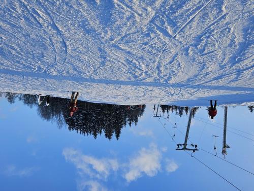 a reflection of a ski lift in the snow at Holiday Home Stárkov by Interhome in Stárkov