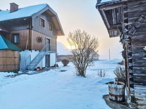 a house in the snow next to a building at Apartment Kulmer Hof by Interhome in Pruggern