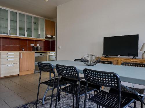 a kitchen with a table and chairs and a television at Apartment Čertovka-2 by Interhome in Harrachov
