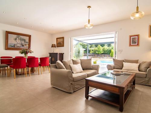 a living room with a couch and a table at Holiday Home Villa D'Allongue by Interhome in Callian
