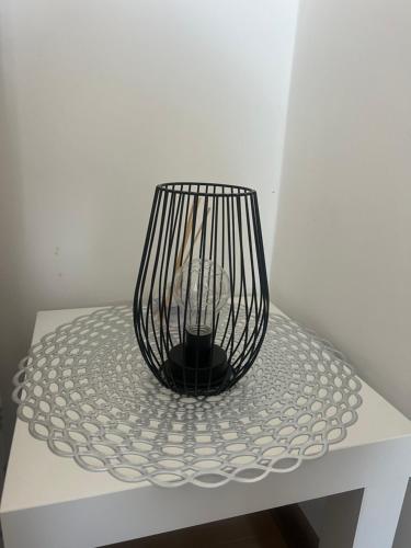a black vase sitting on top of a white table at The GREEN FAMILY paradise in Čajetina