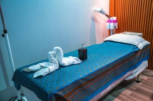 a bed with two towels on top of it at FUNPLACE BEACH in Himmafushi