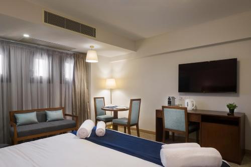 a hotel room with a bed and a desk at Boutique Residence Iconia-Lemon Spaces Zamalek in Cairo