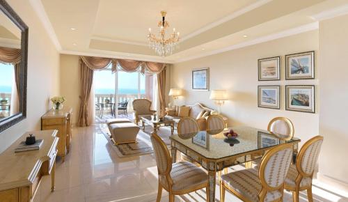 a living room with a table and chairs at Kempinski Hotel & Residences Palm Jumeirah in Dubai