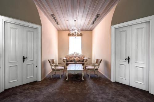 a dining room with a table and chairs and a window at Elegance East Hotel in Antalya