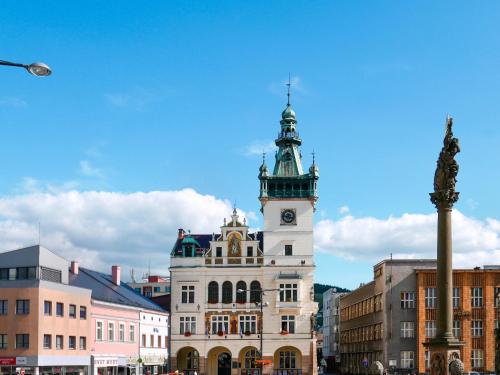 a building with a clock tower on top of it at Holiday Home Stárkov by Interhome in Stárkov