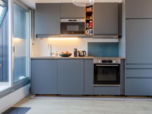 une cuisine avec des armoires bleues et un évier dans l'établissement Apartment La Deauvillaise-5 by Interhome, à Deauville