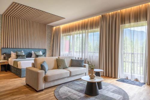 a living room with a couch and a bed at Aldiana Club Salzkammergut und GrimmingTherme in Bad Mitterndorf