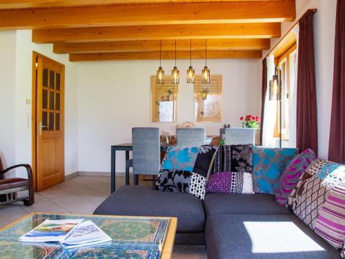 a living room with a couch and a table at Holiday Home Chalet Mirabelle by Interhome in Nendaz