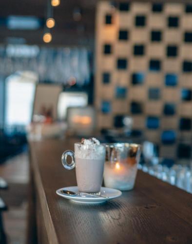two coffee mugs sitting on a counter in a restaurant at ZillergrundRock Luxury Mountain Resort in Mayrhofen