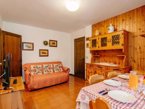 a living room with a table and a couch at Apartment Apt 18 by Interhome in Campitello di Fassa