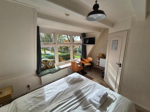 Кровать или кровати в номере De Welvaart - Logement