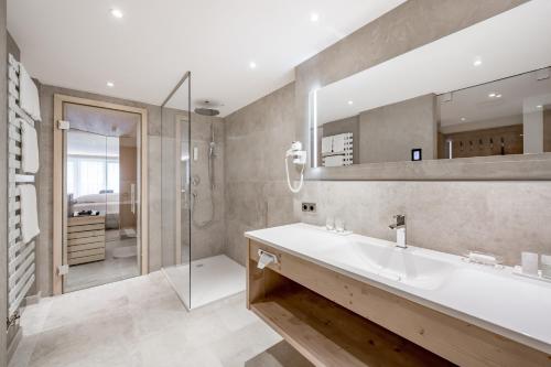 a bathroom with a sink and a shower at Hotel Bellevue - 4 Sterne superior in Obergurgl