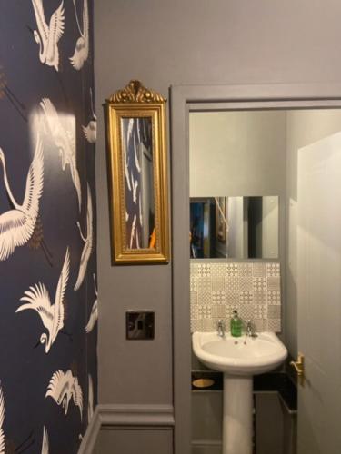 a bathroom with a sink and a mirror at Daiches Braes Brunstane Portobello in Edinburgh