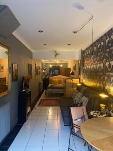 a living room with a couch and a table at Daiches Braes Brunstane Portobello in Edinburgh