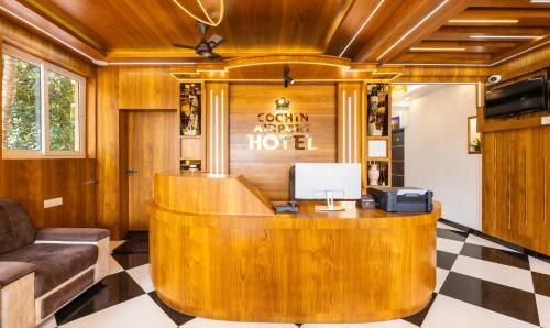 a lobby of a hotel with a reception desk at Treebo Premium Cochin Airport, 5 min From Cochin Airport in Cochin