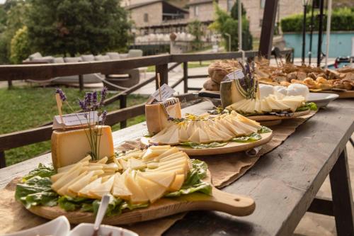 a wooden table with sandwiches and other food on it at Relais Villa D'Assio in Labro Rieti