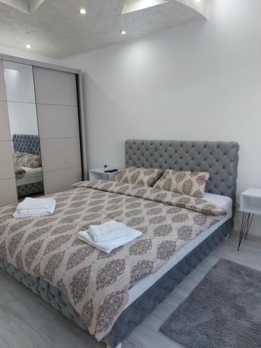 a bedroom with a bed with two towels on it at Sweet home in Šabac