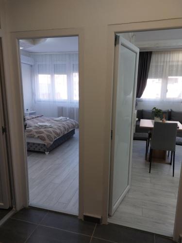a door to a bedroom with a bed in a room at Sweet home in Šabac