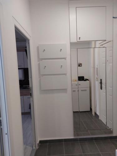 a room with a mirror and a white wall at Sweet home in Šabac