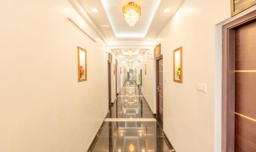 a hallway with glass floors and a chandelier at Treebo Premium Cochin Airport, 5 min From Cochin Airport in Cochin
