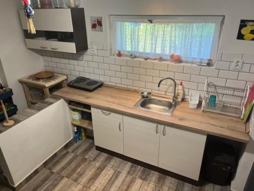 a small kitchen with a sink and a window at Chata Na Mýtině in Čeladná