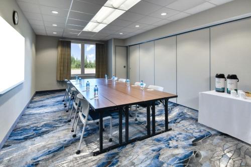 an office meeting room with a long table and chairs at Fairfield Inn & Suites by Marriott Moncton in Moncton