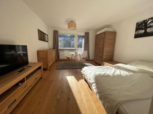 a bedroom with a bed and a flat screen tv at Ferienwohnung Rendl-Blick in Sankt Anton am Arlberg