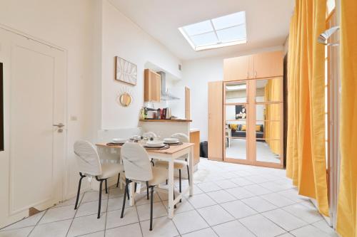 a kitchen and dining room with a table and chairs at Studio Appartement Quartier Musée du Louvre 3 Free Netflix in Paris
