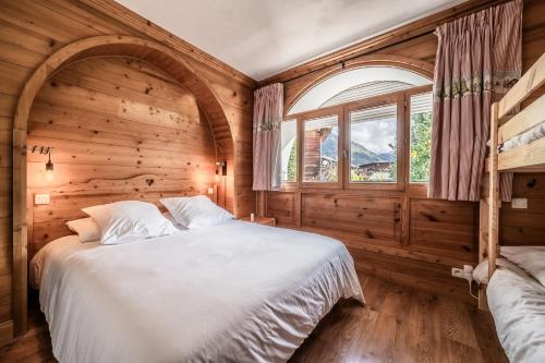 une chambre avec un grand lit et une fenêtre dans l'établissement Lodge 1 : Magnifique deux chambres proche centre, à Morzine